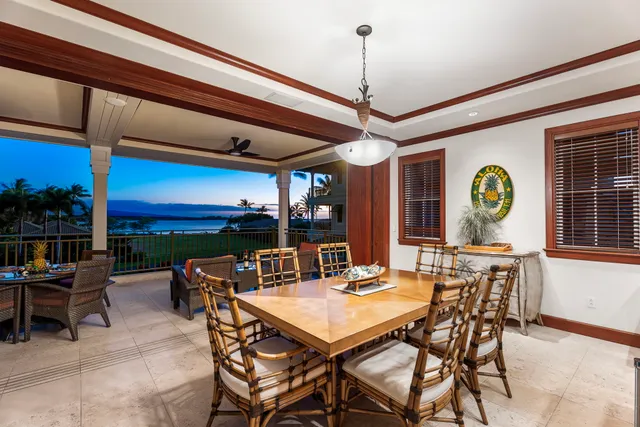 a view of a dining room and hall with furniture