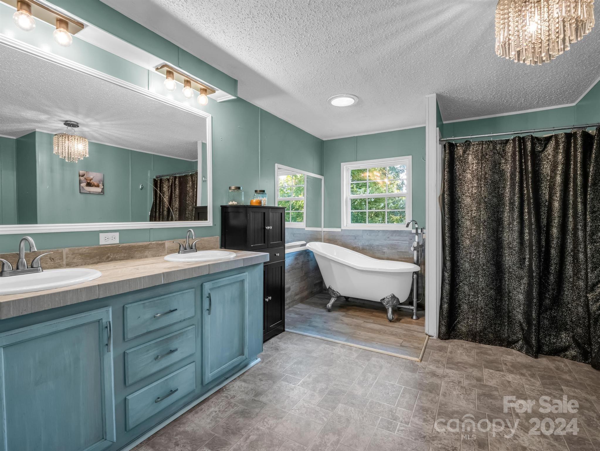293 Bane Road Mills River, NC 28759 - Photo 20 of 48 a spacious bathroom with a double vanity sink and a mirror