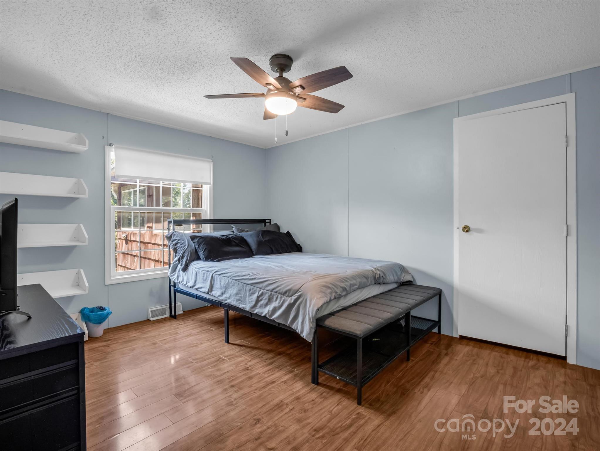 293 Bane Road Mills River, NC 28759 - Photo 24 of 48 a bedroom with a bed and wooden floor