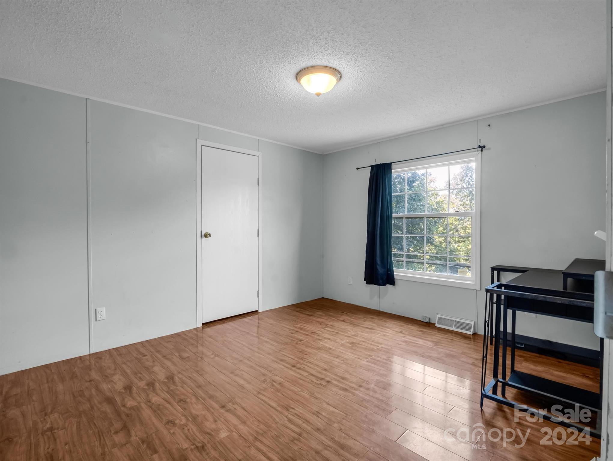 293 Bane Road Mills River, NC 28759 - Photo 27 of 48 wooden floor in an empty room with a window