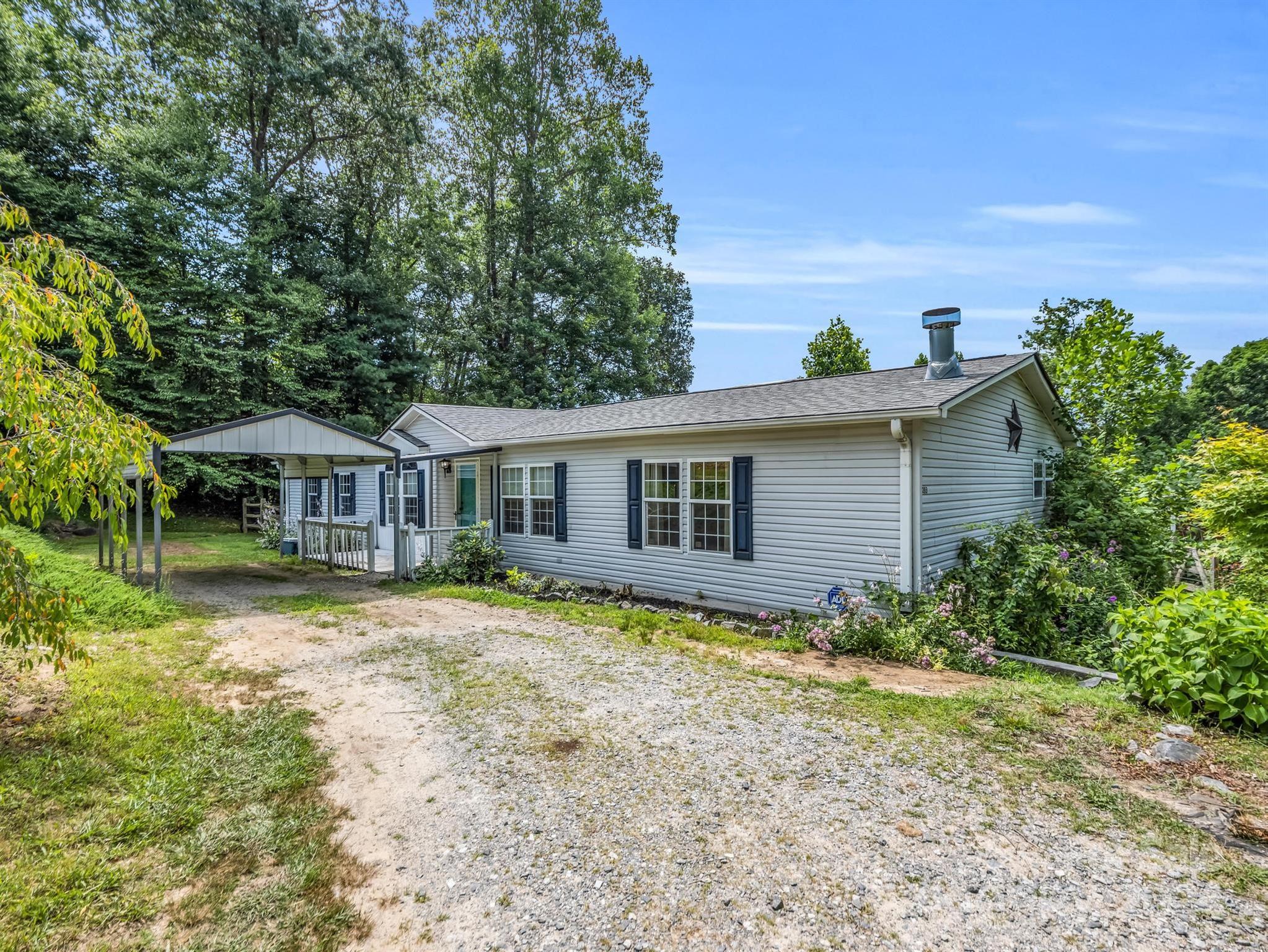 293 Bane Road Mills River, NC 28759 - Photo 3 of 48 a front view of a house with garden