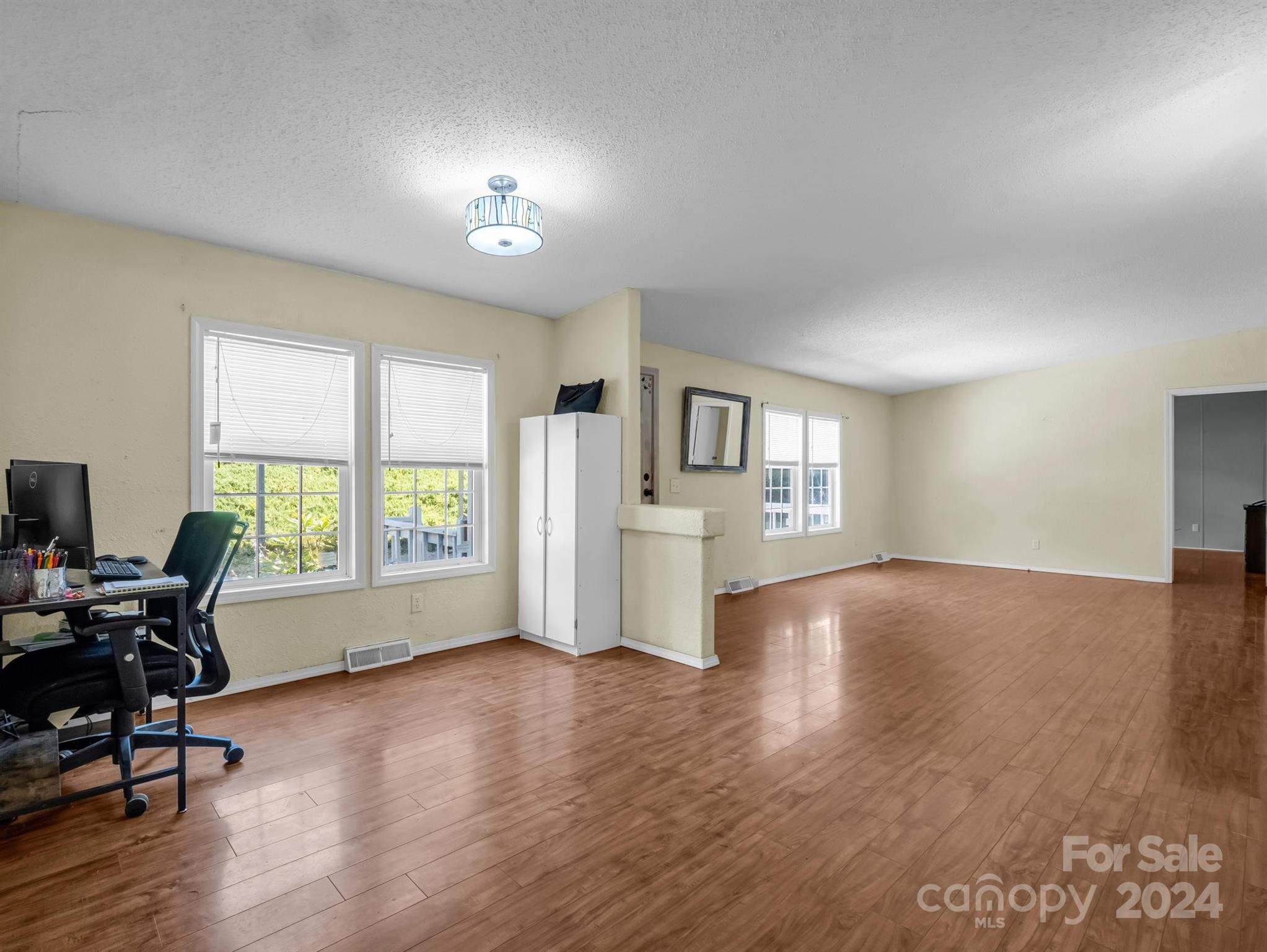 293 Bane Road Mills River, NC 28759 - Photo 8 of 48 a view of an empty room with wooden floor and a window