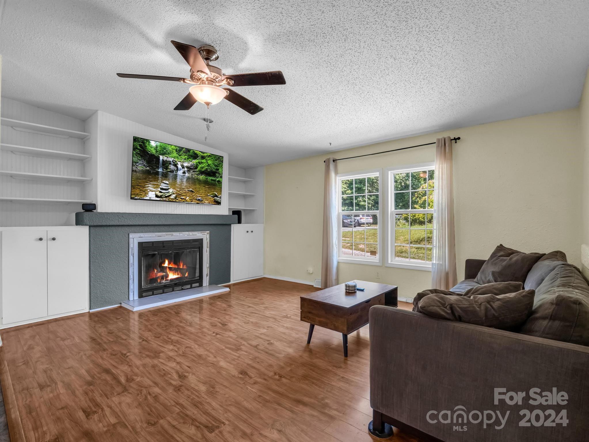 293 Bane Road Mills River, NC 28759 - Photo 9 of 48 a living room with furniture and a fireplace