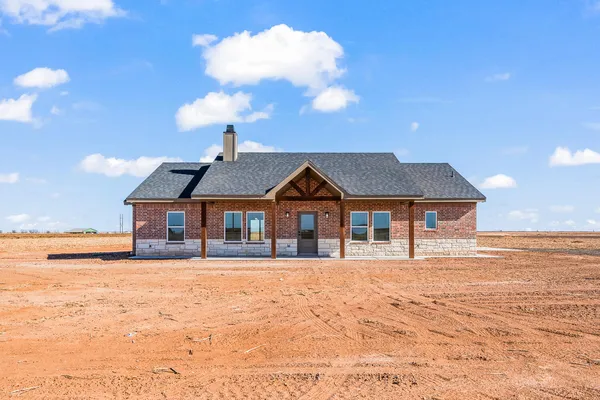 a view of a house with a yard and garage