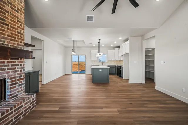 a view of a kitchen with a stove cabinets and wooden floor
