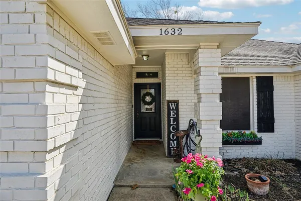 a front view of a house with flowers