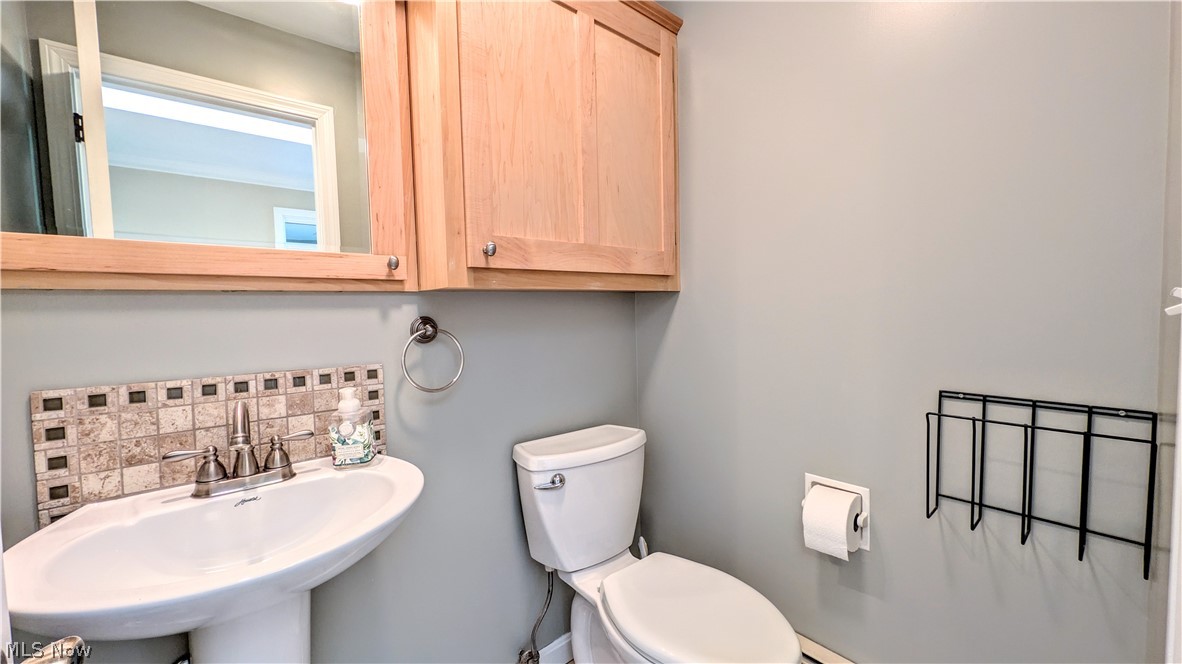 6409 Old Woods Road Ashtabula, OH 44004 - Photo 17 of 43 Pedestal sink with mosaic tile backsplash, complete with a chrome faucet