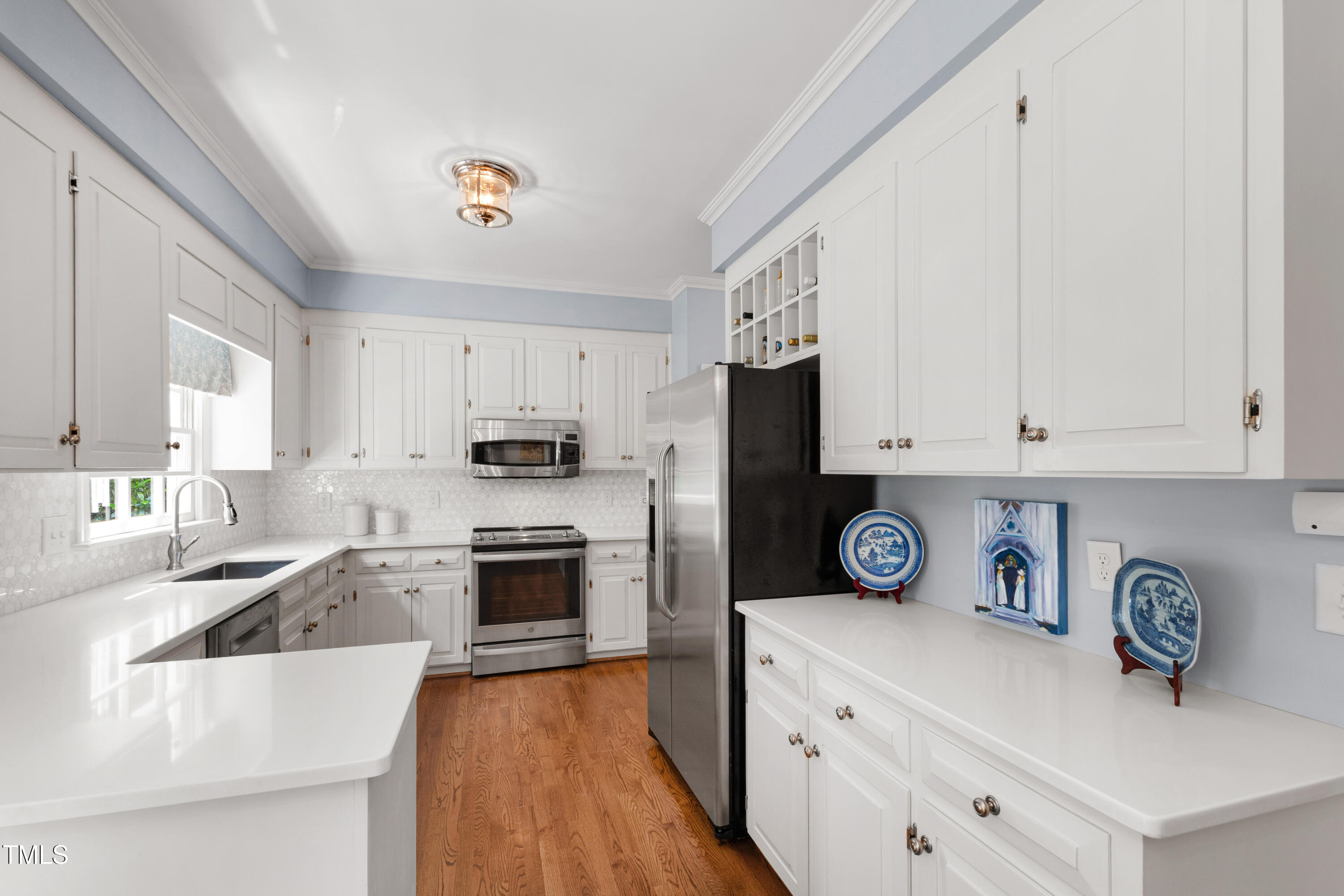 1904 Victoria Road Raleigh, NC 27608 - Photo 12 of 63 a kitchen with stainless steel appliances granite countertop a refrigerator sink and white cabinets