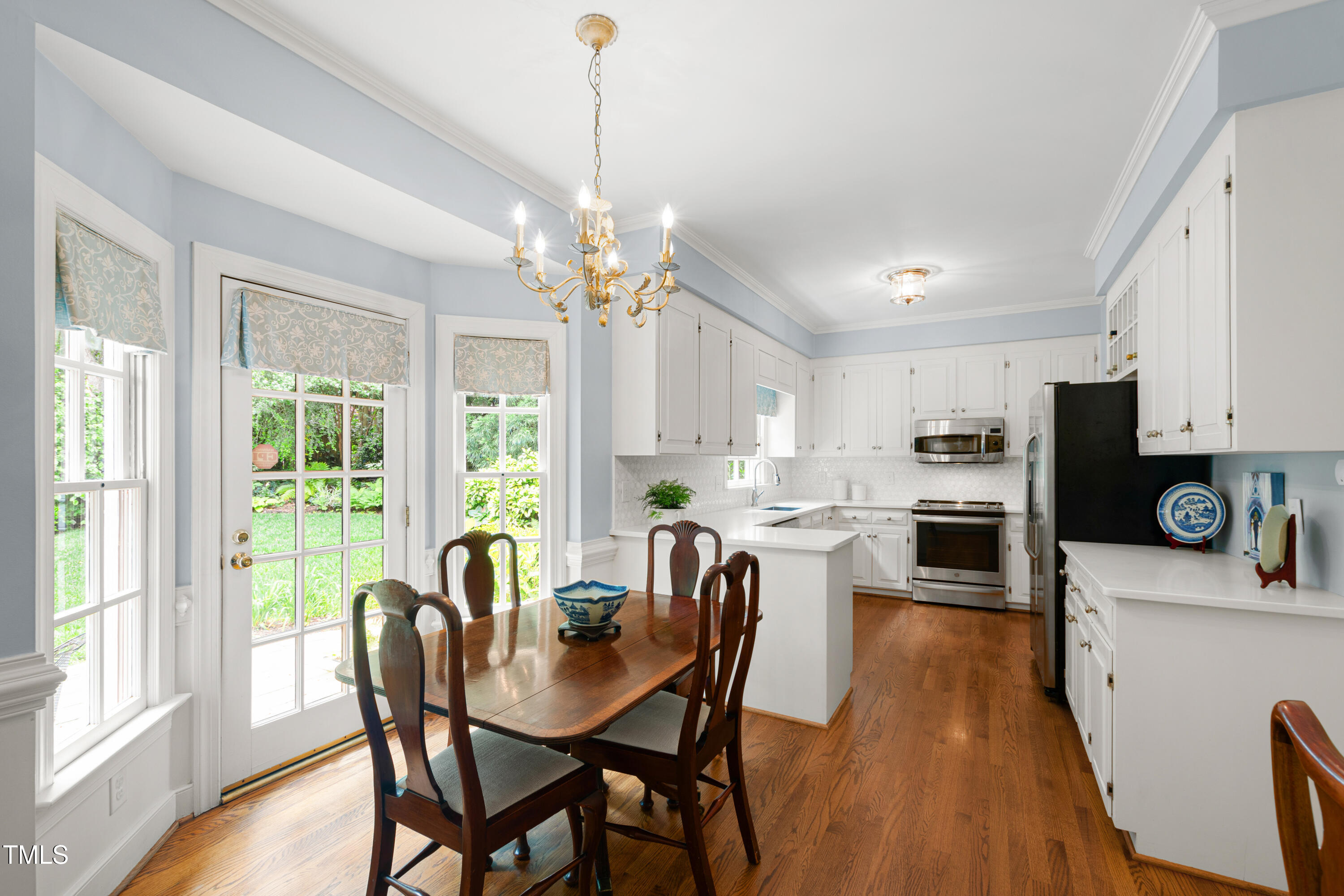 1904 Victoria Road Raleigh, NC 27608 - Photo 16 of 63 a view of a dining room with furniture window and wooden floor