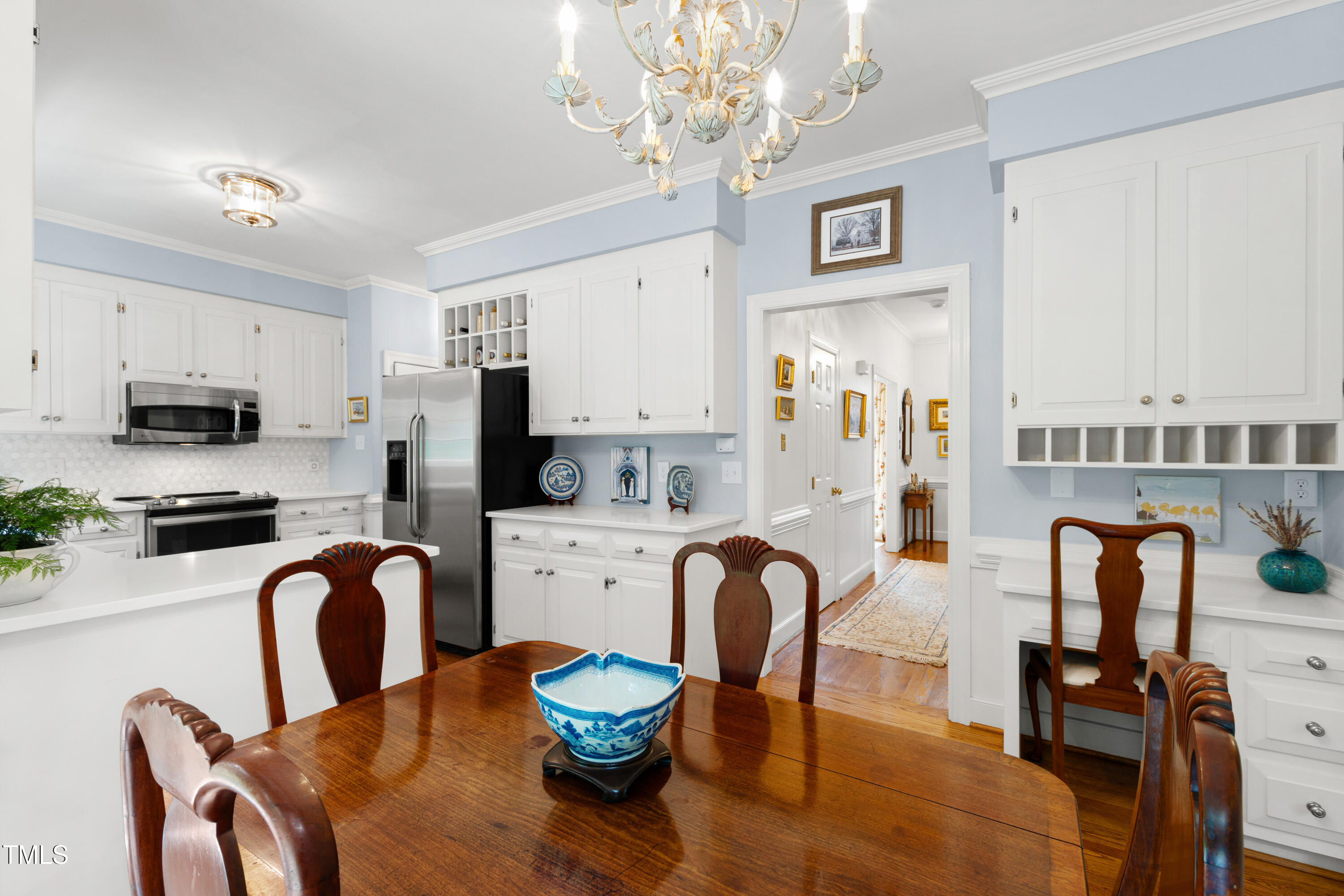 1904 Victoria Road Raleigh, NC 27608 - Photo 17 of 63 a kitchen with stainless steel appliances granite countertop a dining table and chairs