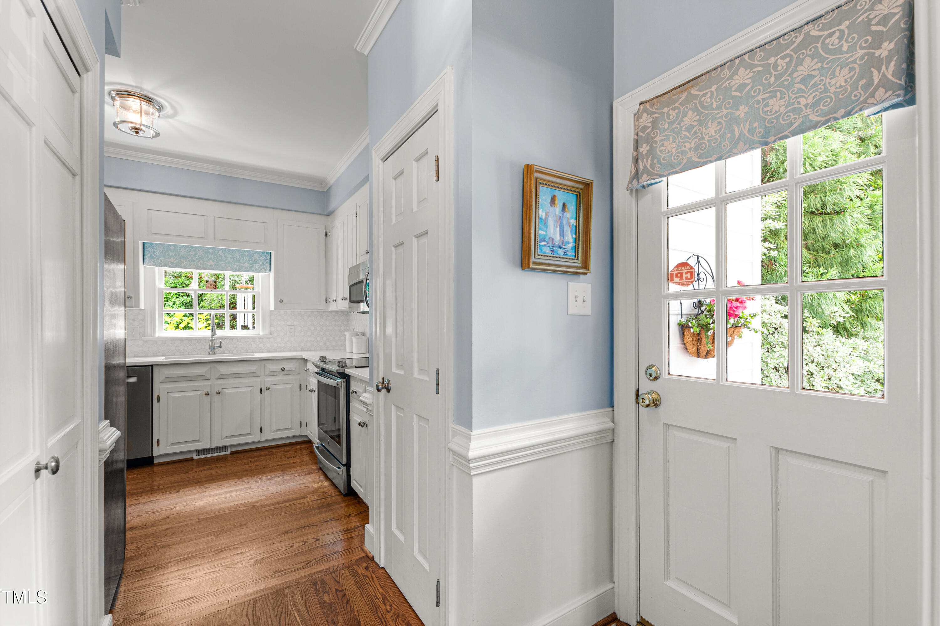 1904 Victoria Road Raleigh, NC 27608 - Photo 19 of 63 a kitchen with a refrigerator a stove a sink and a window