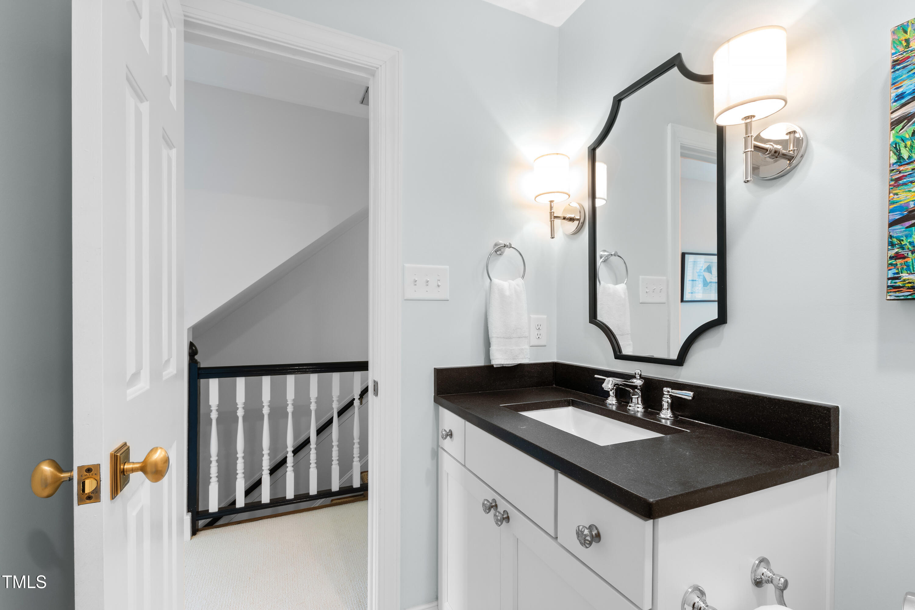 1904 Victoria Road Raleigh, NC 27608 - Photo 42 of 63 a bathroom with a sink and a mirror