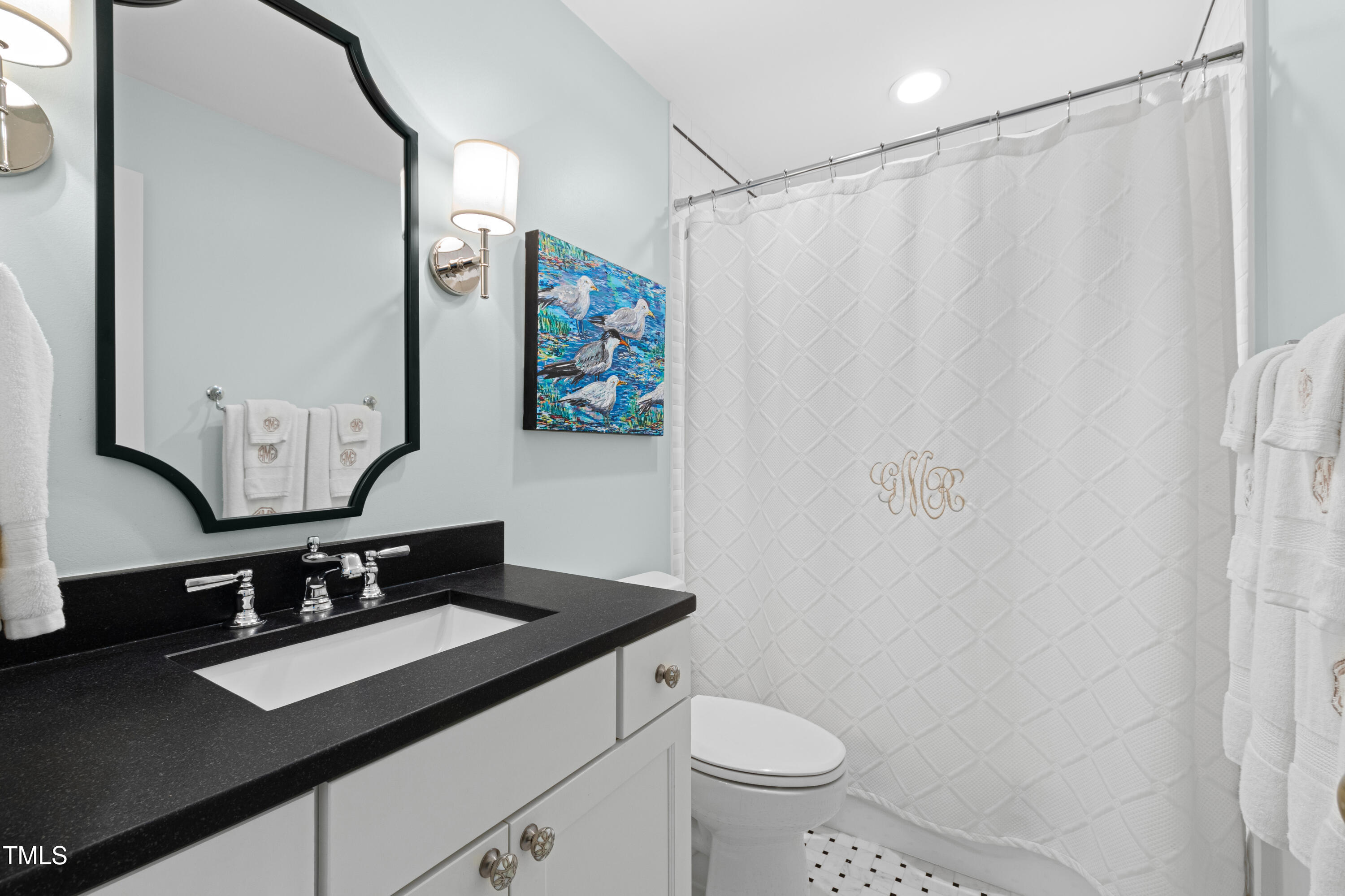 1904 Victoria Road Raleigh, NC 27608 - Photo 44 of 63 a bathroom with a sink and a mirror