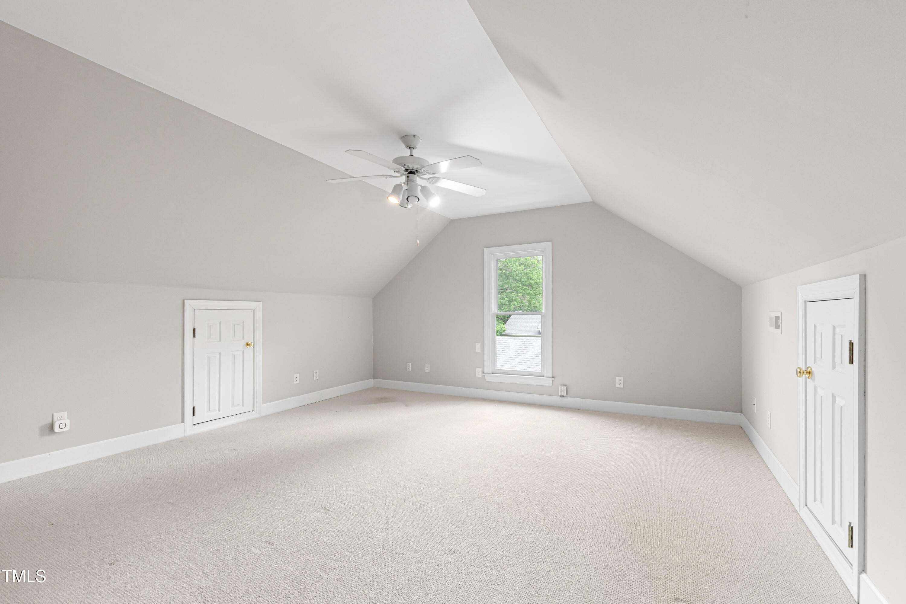 1904 Victoria Road Raleigh, NC 27608 - Photo 49 of 63 an empty room with a chandelier fan and windows