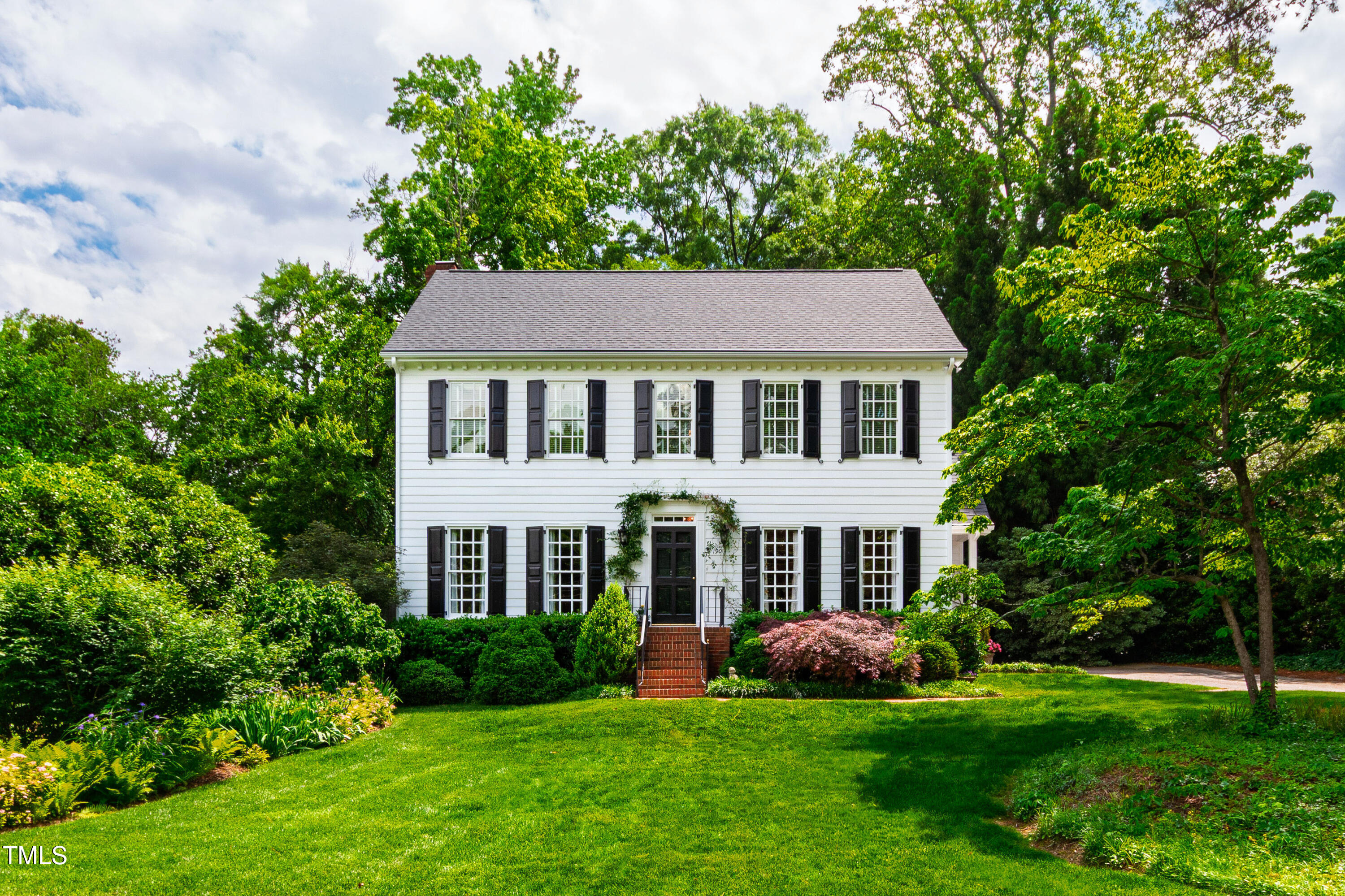 1904 Victoria Road Raleigh, NC 27608 - Photo 63 of 63 a front view of a house with a yard and trees