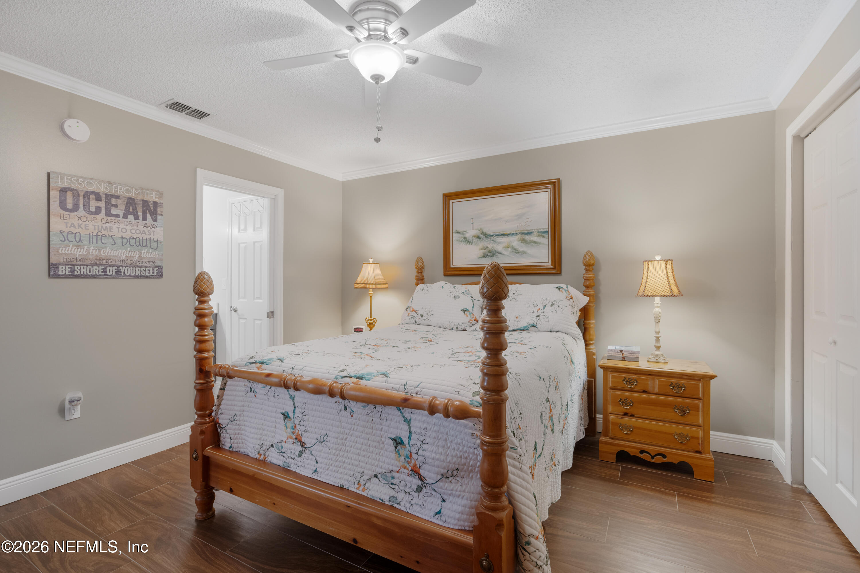 204 Gerado Street, Unit 3 St. Augustine, FL 32080 - Photo 24 of 31 a bedroom with a bed and a chandelier