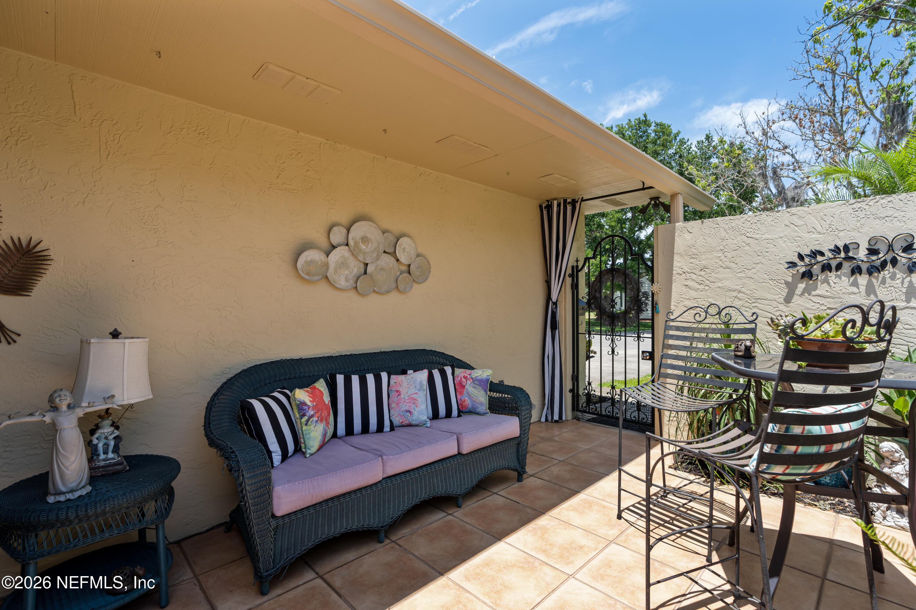 204 Gerado Street, Unit 3 St. Augustine, FL 32080 - Photo 3 of 31 a view of a patio with couches table and chairs and potted plants