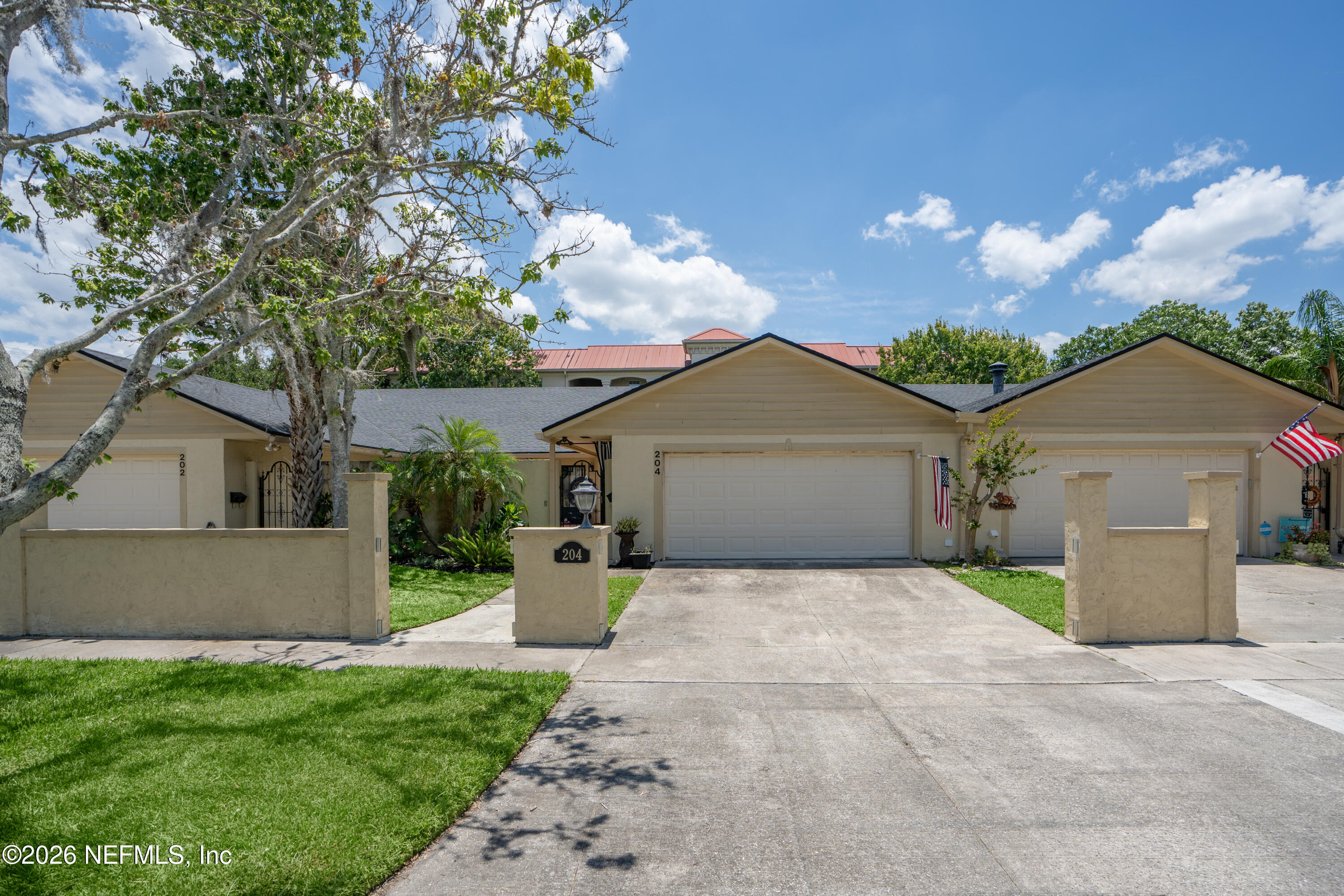 204 Gerado Street, Unit 3 St. Augustine, FL 32080 - Photo 31 of 31 a front view of a house with a yard and garage