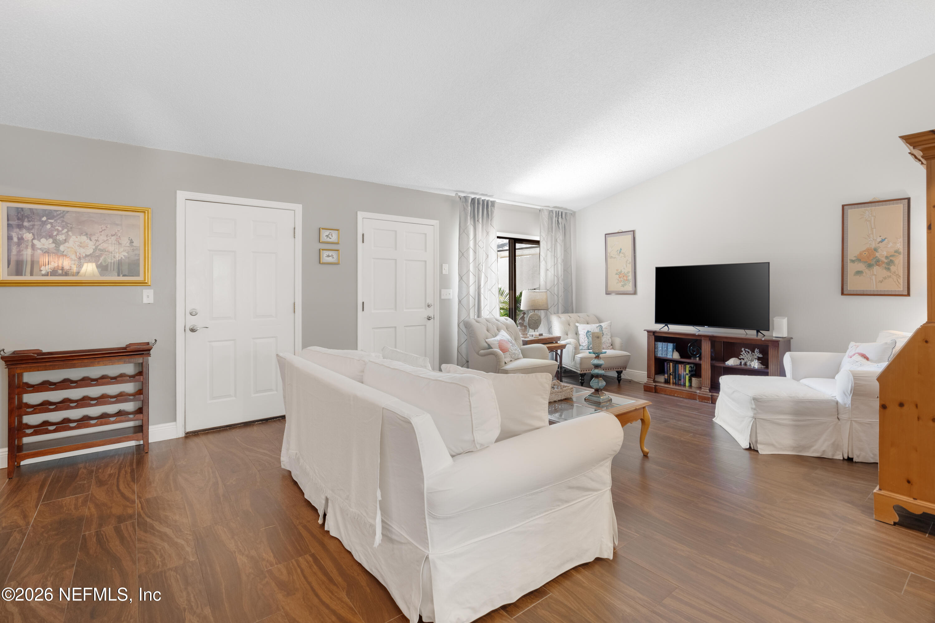 204 Gerado Street, Unit 3 St. Augustine, FL 32080 - Photo 5 of 31 a living room with furniture and a flat screen tv