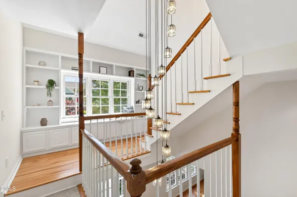 a view of staircase with wooden floor and a rug