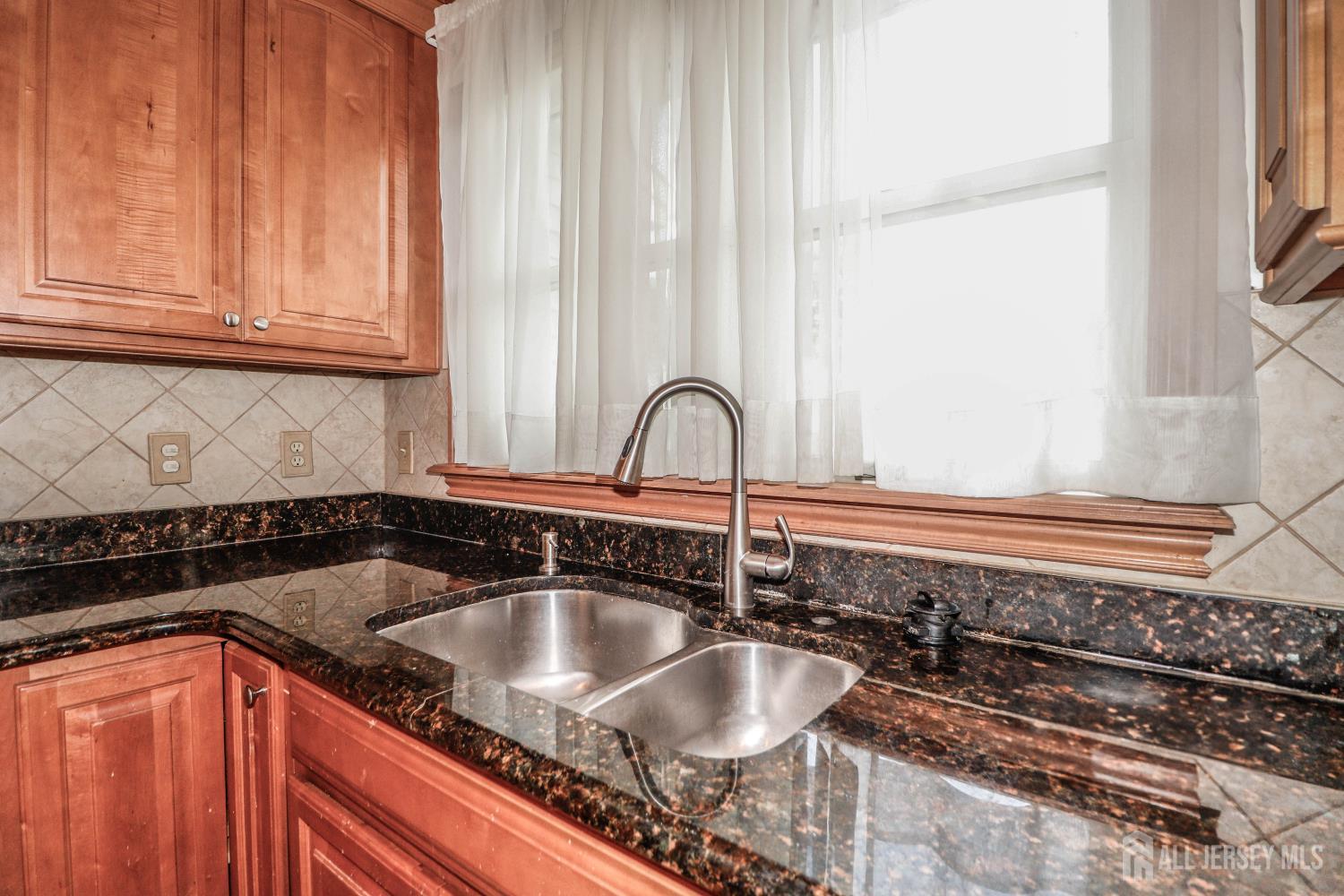 5 Timothy Court Edison, NJ 08837 - Photo 12 of 32 a kitchen with granite countertop a sink and a stove
