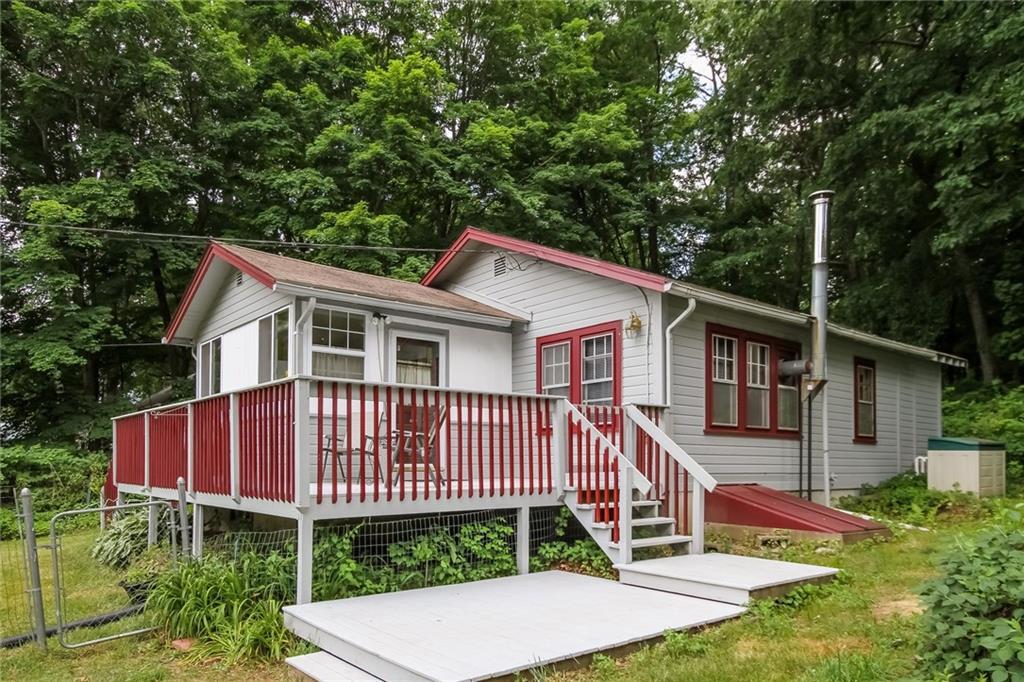 149 Lake Road Andover, CT 06232 - Photo 1 of 1 a view of a house with a yard and deck