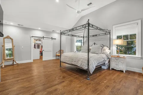 a bedroom with a large bed and a window