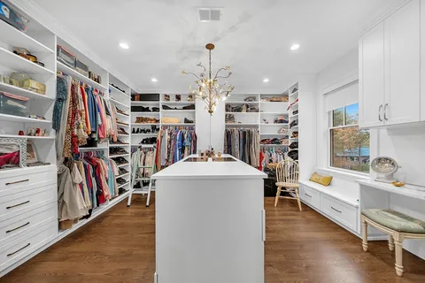 a living room with lots of furniture and a book shelf