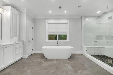 a bathroom with a bathtub and shower