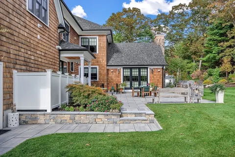 a front view of a house with a garden and plants