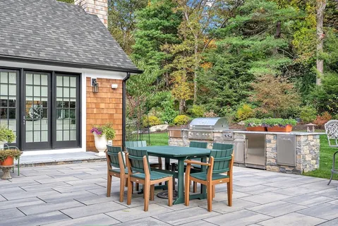 an outdoor space with furniture and garden