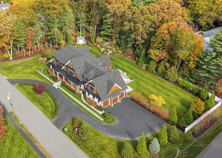 an aerial view of a house with a yard