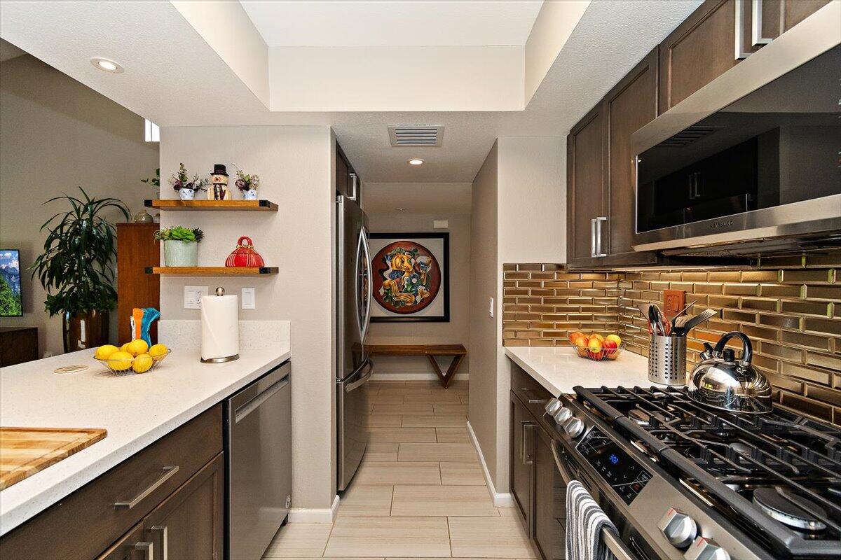 200 East Racquet Club Road, Unit 4 Palm Springs, CA 92262 - Photo 1 of 1 a kitchen with a stove and a microwave