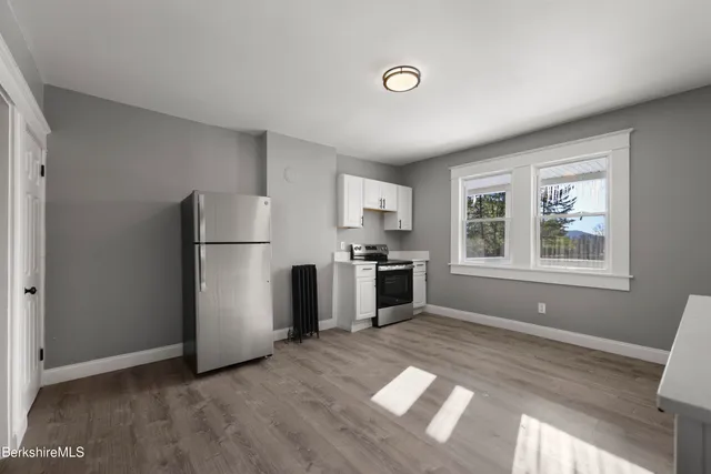 a kitchen with stainless steel appliances granite countertop a refrigerator sink and stove