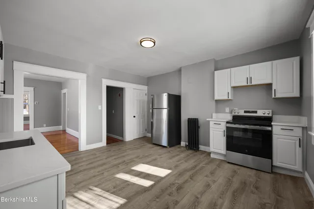 a kitchen with stainless steel appliances granite countertop a refrigerator stove and sink