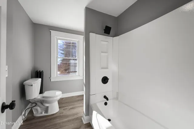 a bathroom with a toilet and a shower