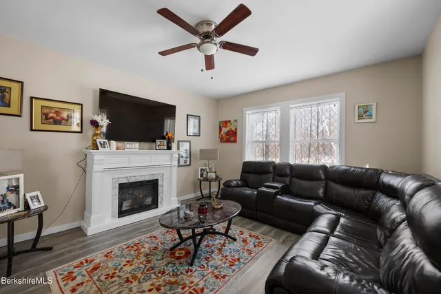 a living room with furniture a fireplace and a flat screen tv