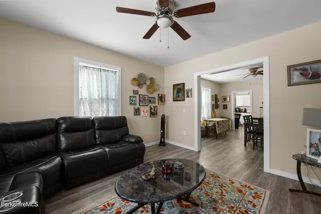 a living room with furniture and a wooden floor