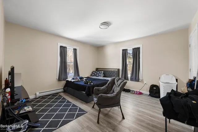 a bedroom with furniture and a wooden floor