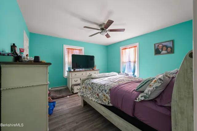 a bedroom with a bed and a flat screen tv