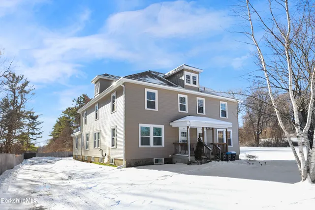 a front view of a building with a yard