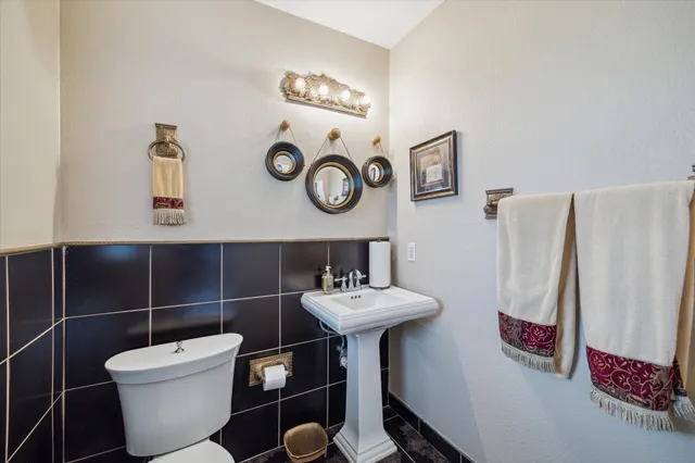 a bathroom with a sink toilet and a mirror