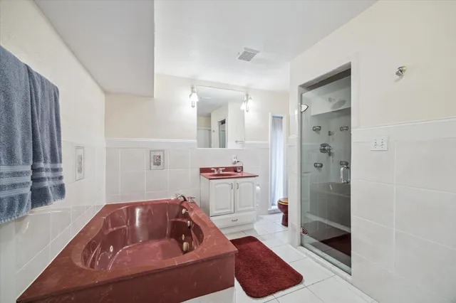 a bathroom with a tub sink and shower
