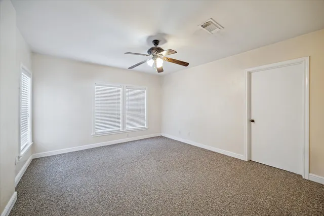 a view of room with a ceiling fan and window
