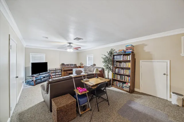 a workspace with a flat screen tv and a couch