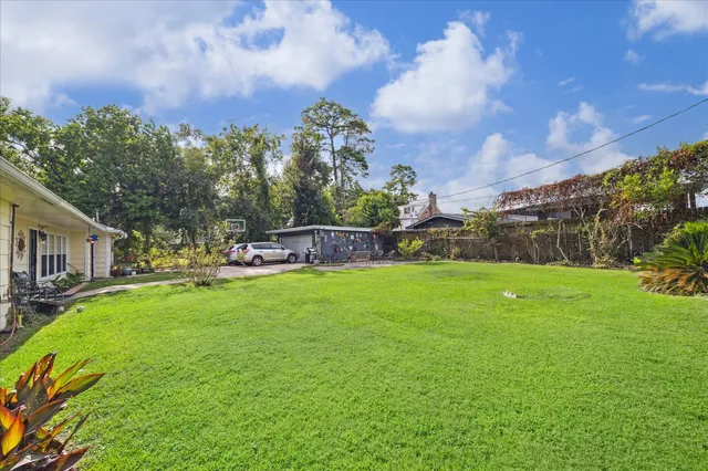 a view of a fountain in front of a house with a big yard