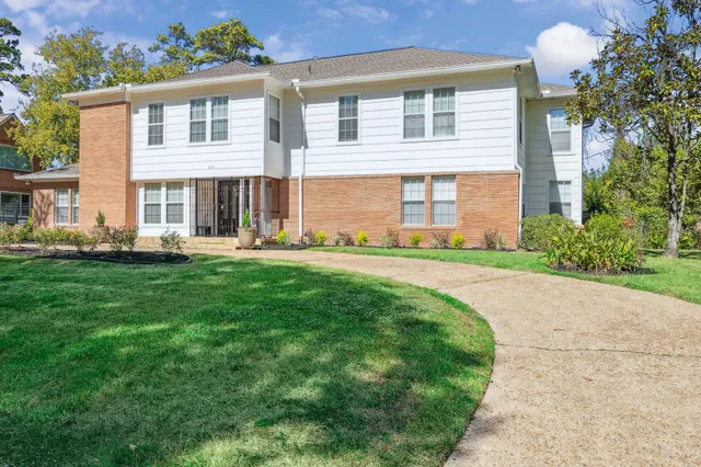 a front view of house with yard and green space
