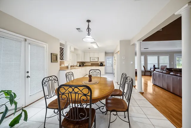a dining room with furniture and wooden floor