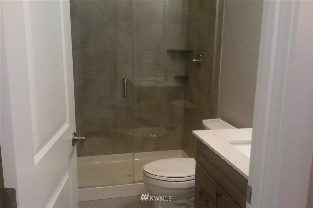 4323 223rd Place Southeast Bothell, WA 98021 - Photo 12 of 15 a bathroom with a sink a toilet and shower