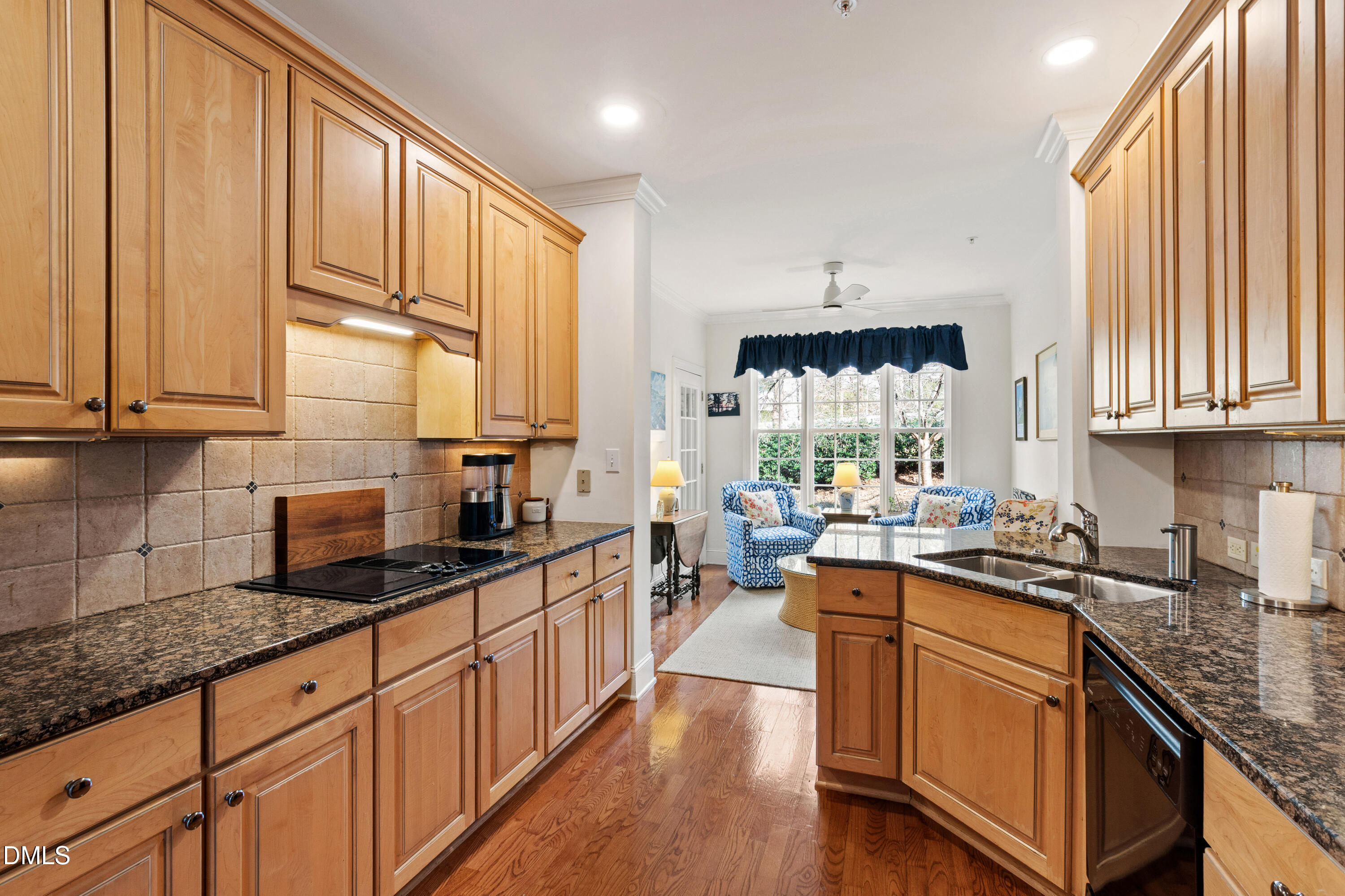 3700 Baron Cooper Pass, Unit 105 Raleigh, NC 27612 - Photo 38 of 49 a kitchen with stainless steel appliances granite countertop a stove a sink dishwasher and cabinets with wooden floor